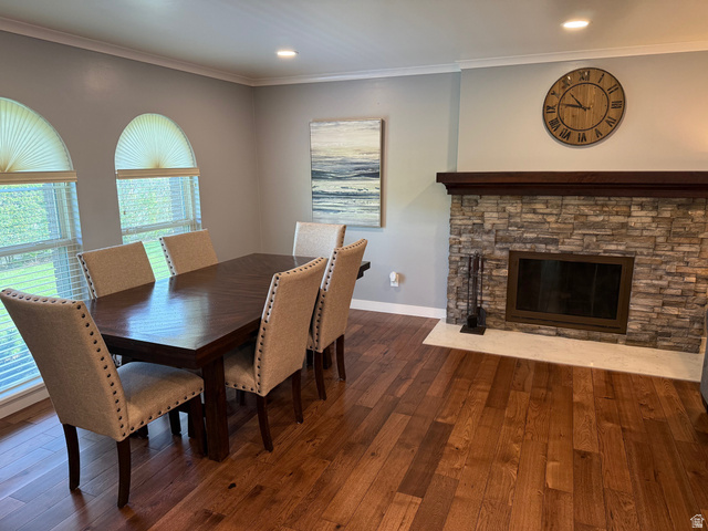 362 East 9150th Street South Sandy, UT 84070 - Photo 3 of 41 Dining area with dark wood finished floors, ornamental molding, a stone fireplace, and recessed lighting