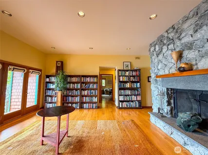 a living room with furniture a rug and a book shelf
