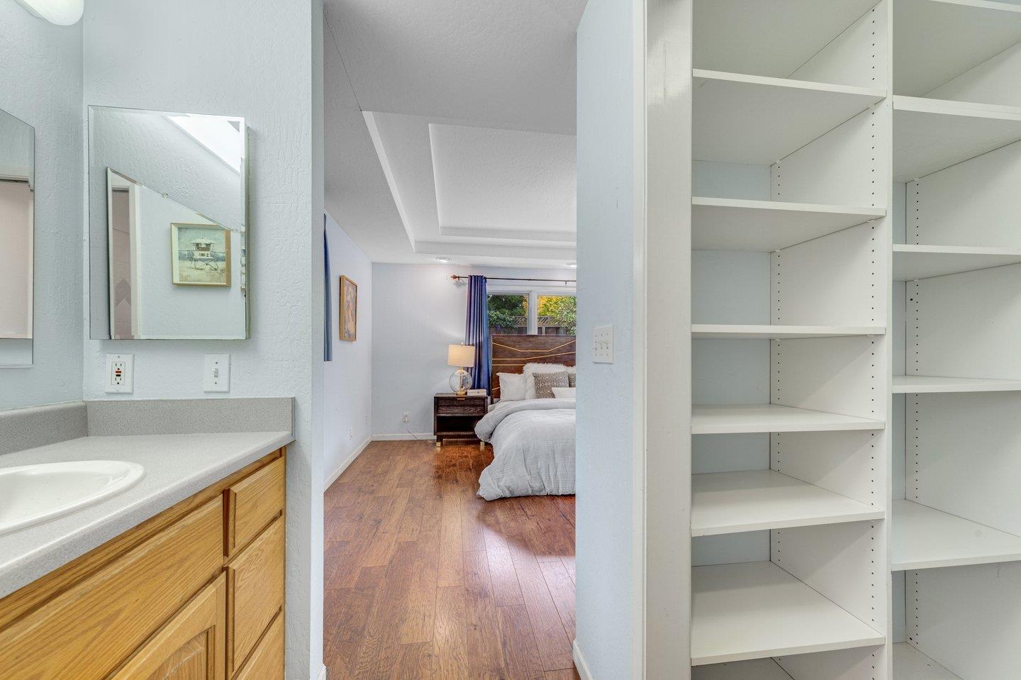 390 Cecelia Way Los Altos, CA 94022 - Photo 31 of 48 a hallway with a sink and a wooden floor
