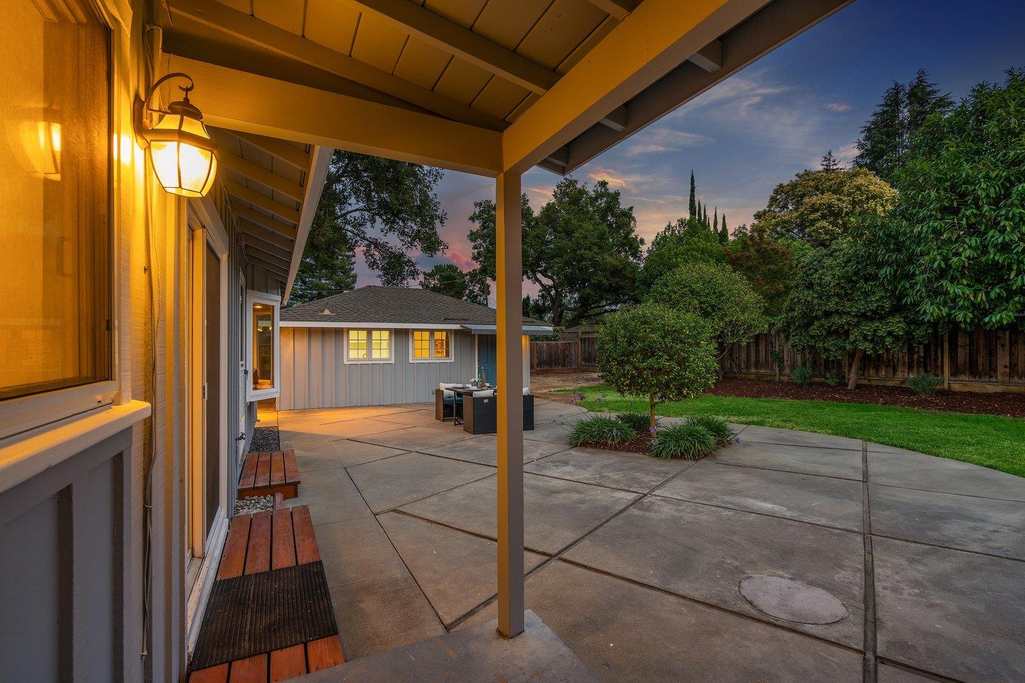 390 Cecelia Way Los Altos, CA 94022 - Photo 36 of 48 a view of a patio with table and chairs potted plants with wooden floor and fence