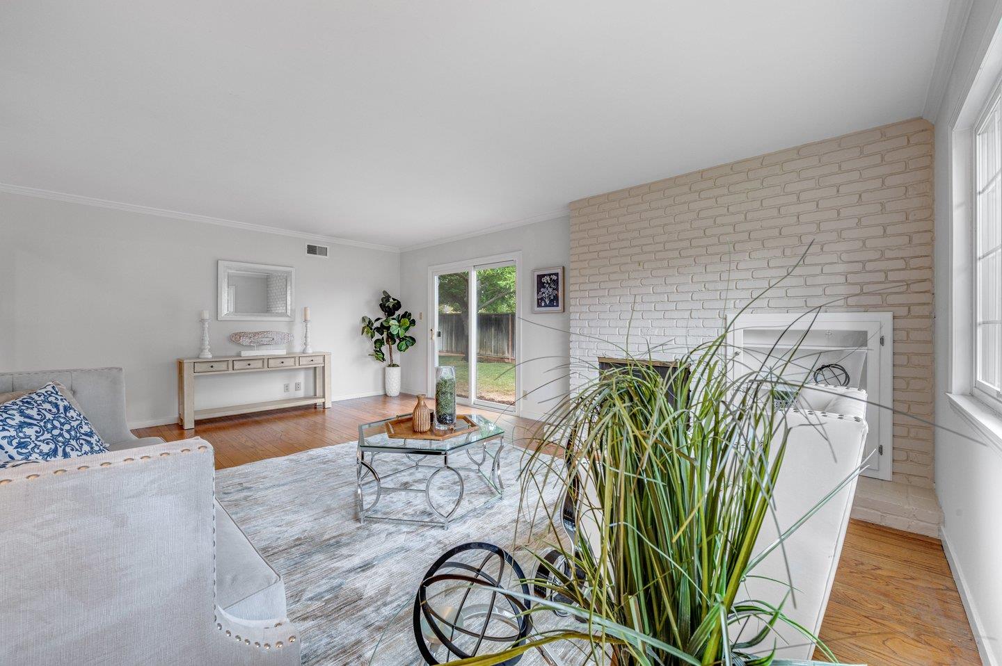 390 Cecelia Way Los Altos, CA 94022 - Photo 7 of 48 a living room with furniture a potted plant and a table
