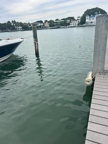 a front view of a house with a garden and parking space