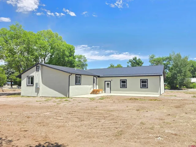 a house with trees in the background