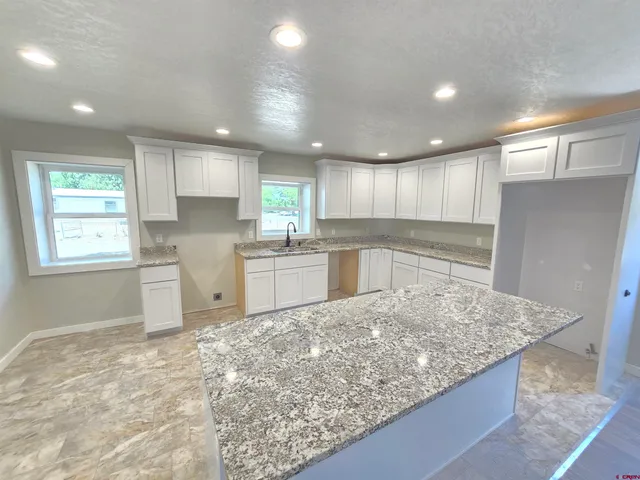 a kitchen with a sink stove and refrigerator