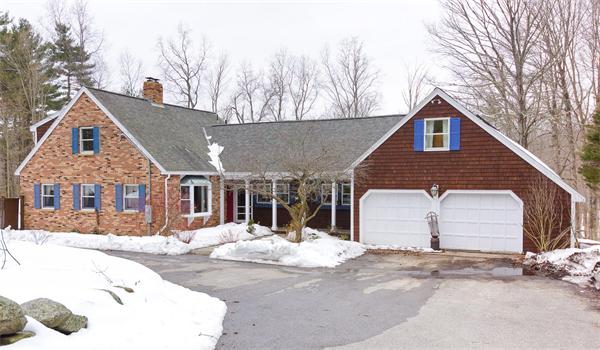 41 Frye Road Bolton, MA 01740 - Photo 1 of 24 a front view of a house with a yard and garage