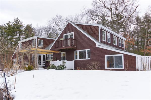 41 Frye Road Bolton, MA 01740 - Photo 2 of 24 a front view of a house with a yard covered in snow