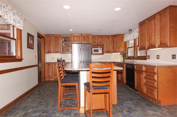 41 Frye Road Bolton, MA 01740 - Photo 4 of 24 a kitchen with stainless steel appliances a refrigerator a stove a sink dishwasher and a stove with wooden floor