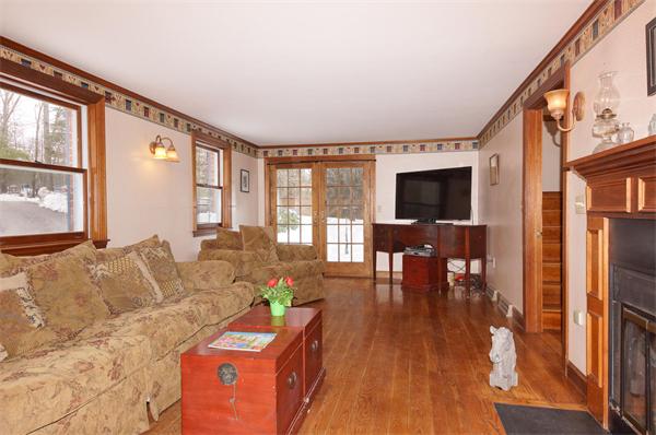 41 Frye Road Bolton, MA 01740 - Photo 7 of 24 a living room with furniture and a flat screen tv