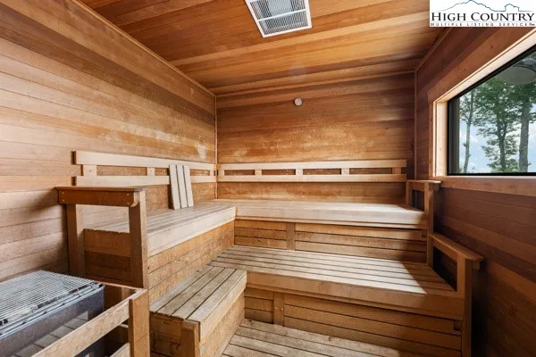 an aerial view of a house with a yard and lake view