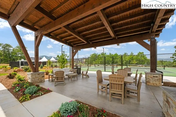 a view of a lake with couches chairs