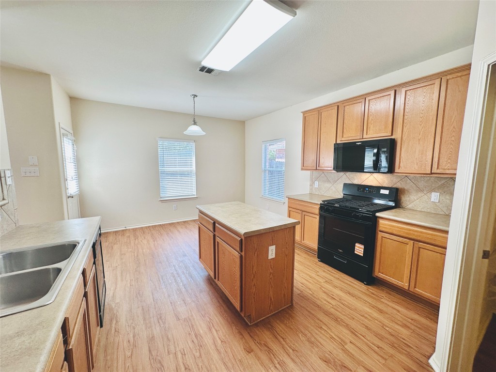 2205 Boyds Way Austin, TX 78748 - Photo 12 of 40 a kitchen with granite countertop a stove top oven and cabinets