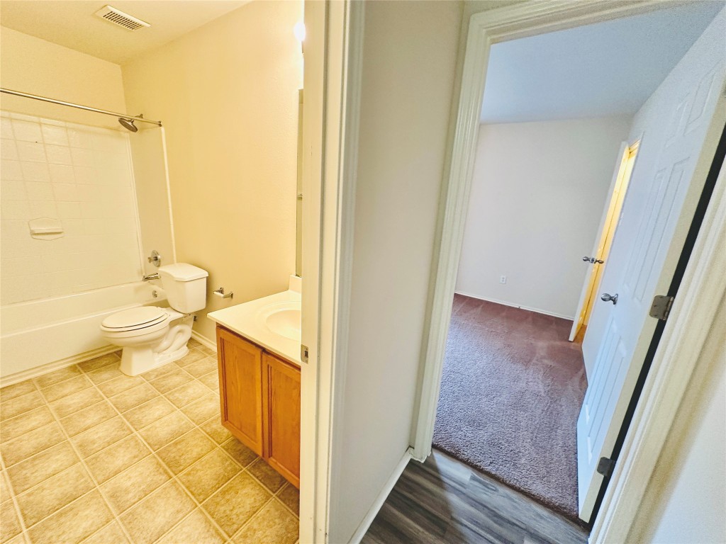 2205 Boyds Way Austin, TX 78748 - Photo 24 of 40 a bathroom with a granite countertop sink toilet and shower