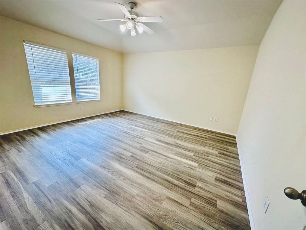 2205 Boyds Way Austin, TX 78748 - Photo 34 of 40 a view of an empty room with wooden floor and a window