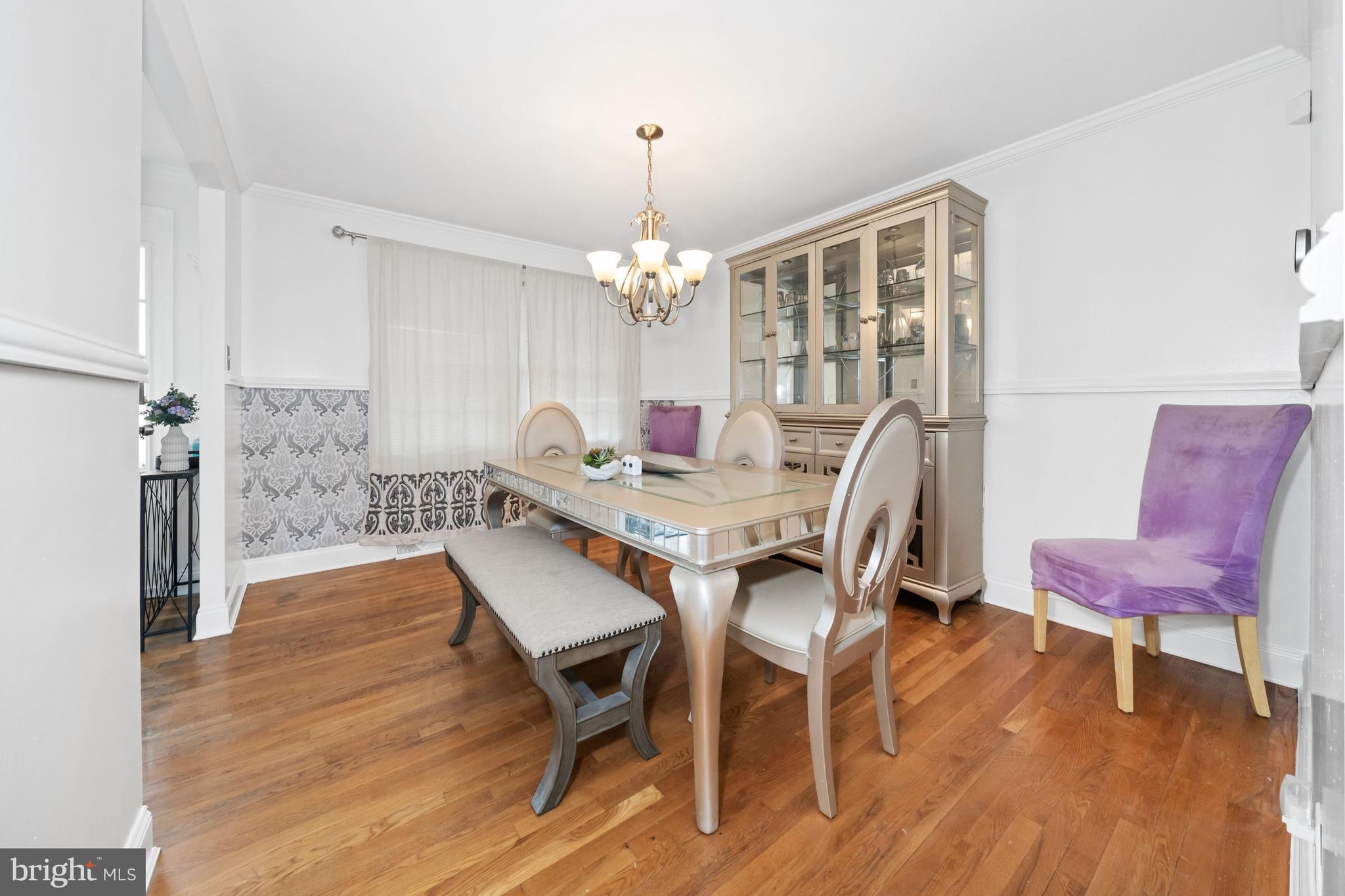 18 George Read Road New Castle, DE 19720 - Photo 14 of 40 a dining room with furniture a chandelier and wooden floor