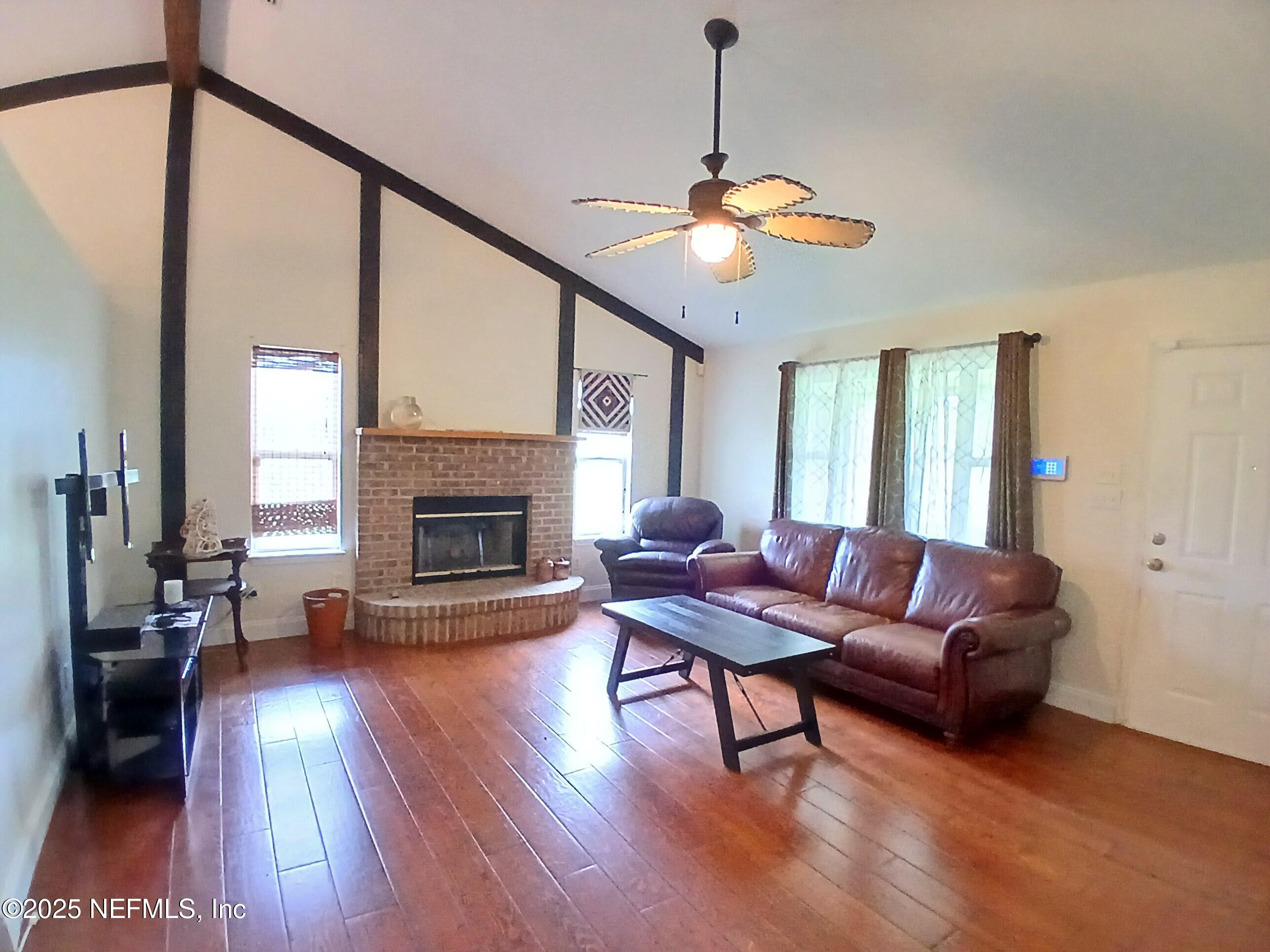 8905 Reid Packing House Road Hastings, FL 32145 - Photo 9 of 40 a living room with furniture and a fireplace