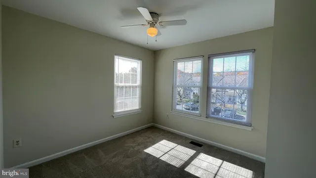 a view of an empty room with windows