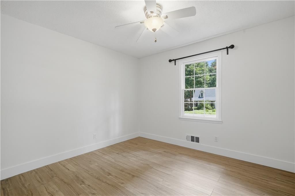 125 Childers Road Canton, GA 30115 - Photo 32 of 48 an empty room with wooden floor and windows
