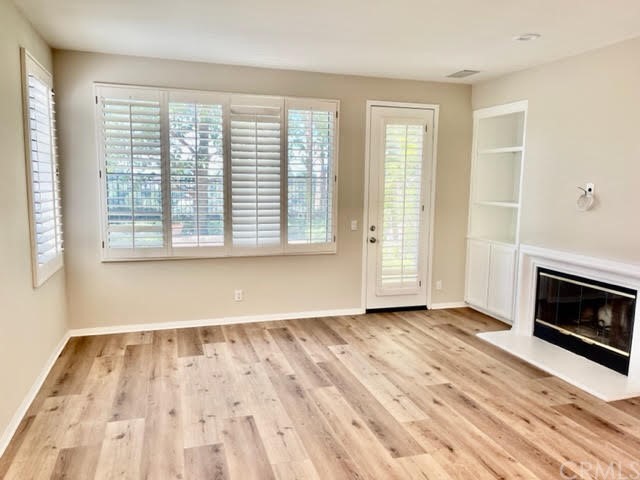 19 Avignon Newport Coast, CA 92657 - Photo 6 of 14 a view of an empty room with wooden floor and a window