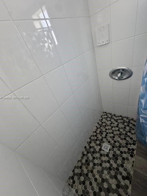 7638 North Miami Avenue, Unit 4 Miami, FL 33150 - Photo 3 of 11 a bathroom with a sink a toilet and a mirror