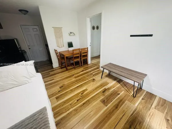 a spacious bedroom with a bed and a dresser