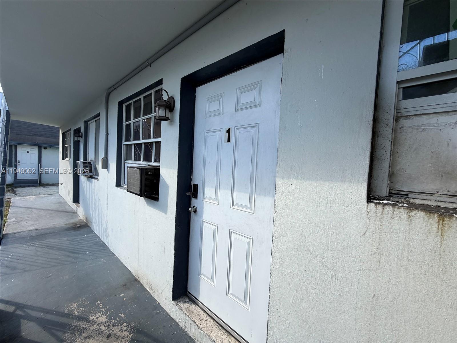 7638 North Miami Avenue, Unit 4 Miami, FL 33150 - Photo 6 of 11 a view of a hallway with wooden floor and dining room