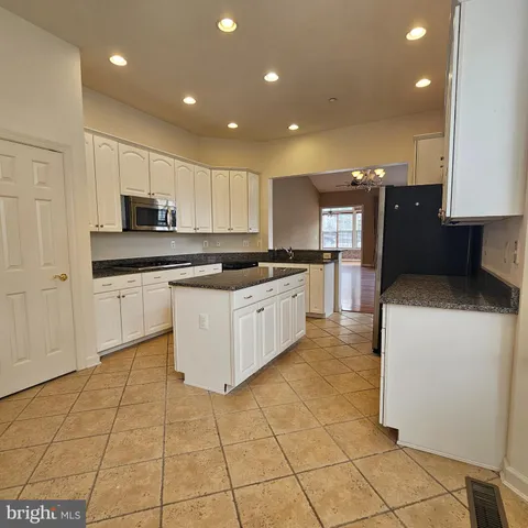 a kitchen with stainless steel appliances granite countertop a stove top oven a sink a counter top space and cabinets