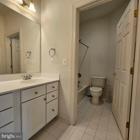 a bathroom with a double vanity sink toilet and shower