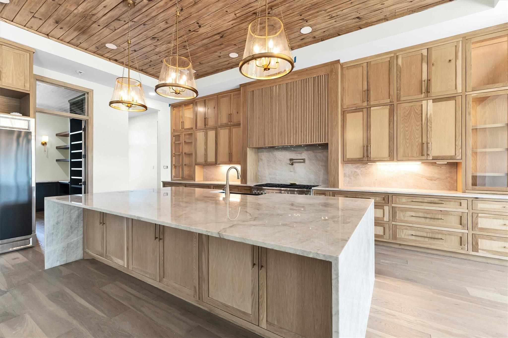 23701 Birch Grove Road Montgomery, TX 77316 - Photo 10 of 50 An expansive 11-foot kitchen island with sleek under-counter storage offers both style and functionality for culinary enthusiasts.
