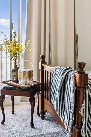 a living room with furniture a flat screen tv and a large window
