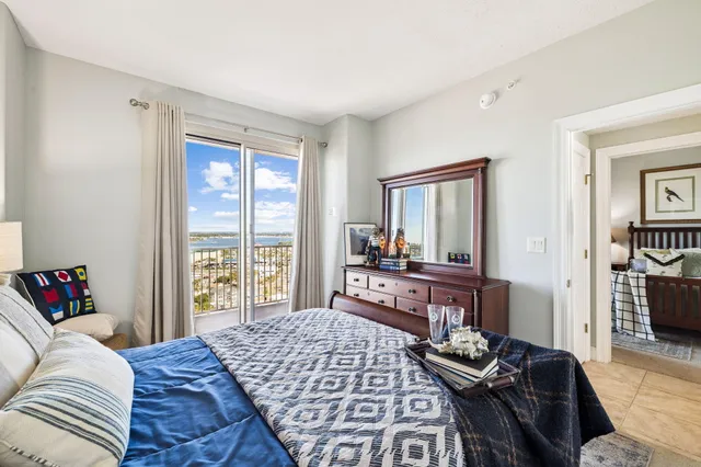 a living room with furniture a flat screen tv and a table