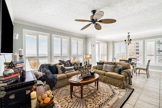 a living room with furniture and a painting on the wall