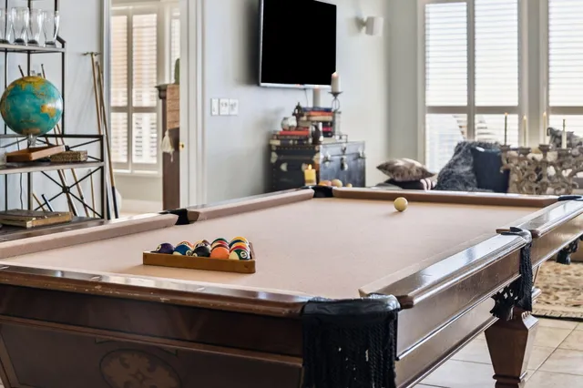 a living room with furniture a large window and gym equipment
