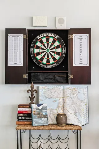 a living room with furniture a flat screen tv and a window