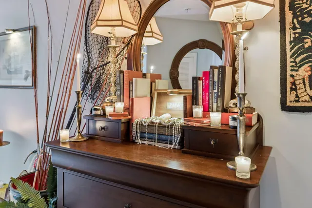 a living room with furniture a flat screen tv and kitchen view