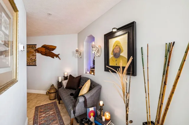 a view of a dining room with furniture and a potted plant
