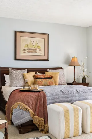 a bedroom with a bed and lamp