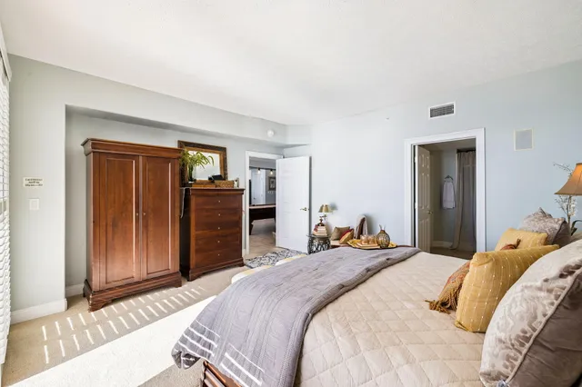 a bedroom with a bed and painting on the wall