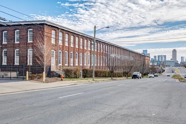 a view of a cars park in front of a building