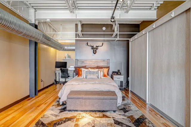 a bed room with a bed and a chandelier