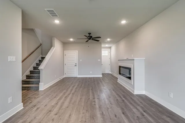 wooden floor in an empty room with a fireplace