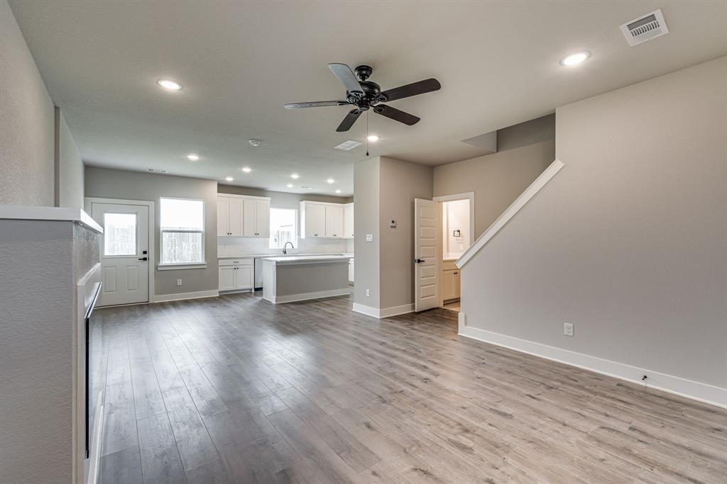 920 Cooksey Court, Unit B Grandview, TX 76050 - Photo 21 of 27 a view of an empty room with wooden floor and a window