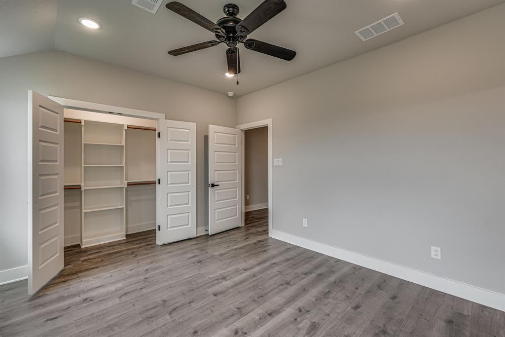 920 Cooksey Court, Unit B Grandview, TX 76050 - Photo 9 of 27 an empty room with a empty space and windows
