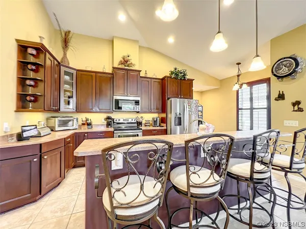 a kitchen with stainless steel appliances granite countertop a sink and a microwave