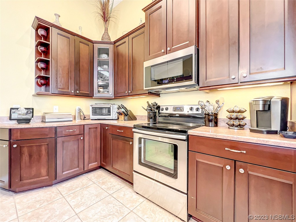 407 Northstar Lane Edgewater, FL 32141 - Photo 16 of 47 a kitchen with stainless steel appliances granite countertop a sink and a microwave