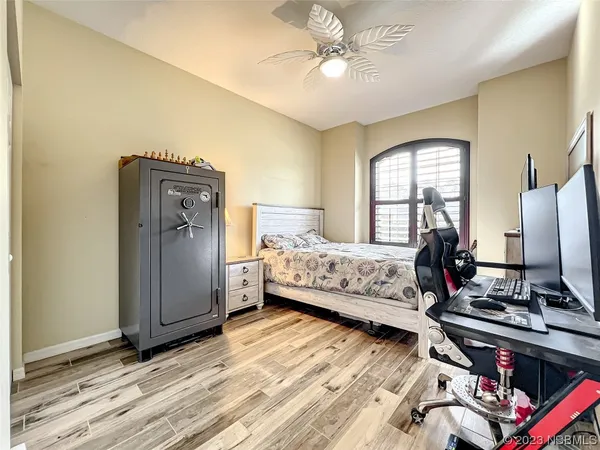 a room with gym equipment and wooden floor