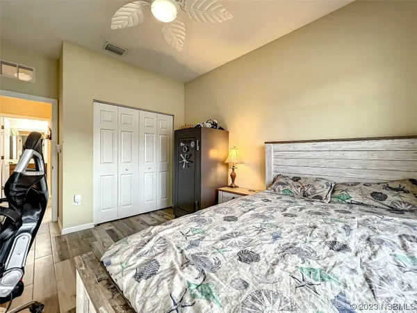 a bedroom with a large bed and a chandelier