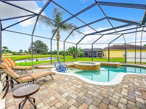 a swimming pool with patio outdoor seating and yard