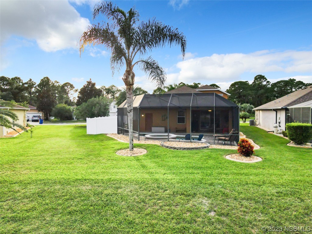 407 Northstar Lane Edgewater, FL 32141 - Photo 45 of 47 a front view of a house with patio and garden