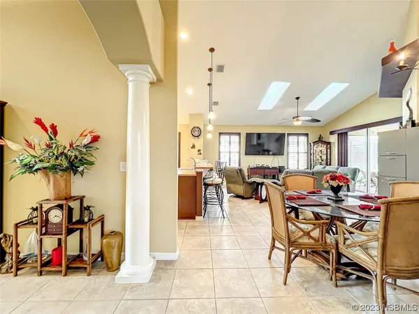 a large kitchen with a table and chairs