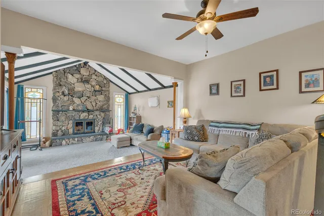 a living room with furniture a fireplace and a chandelier